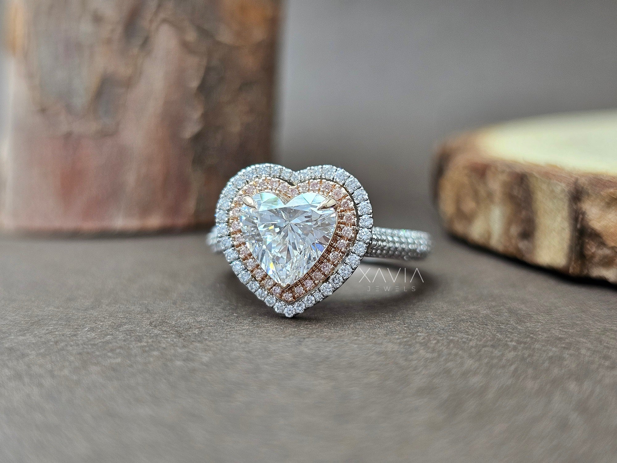 Heart-shaped diamond ring with rose gold and silver accents on a neutral background - Xavia Jewels